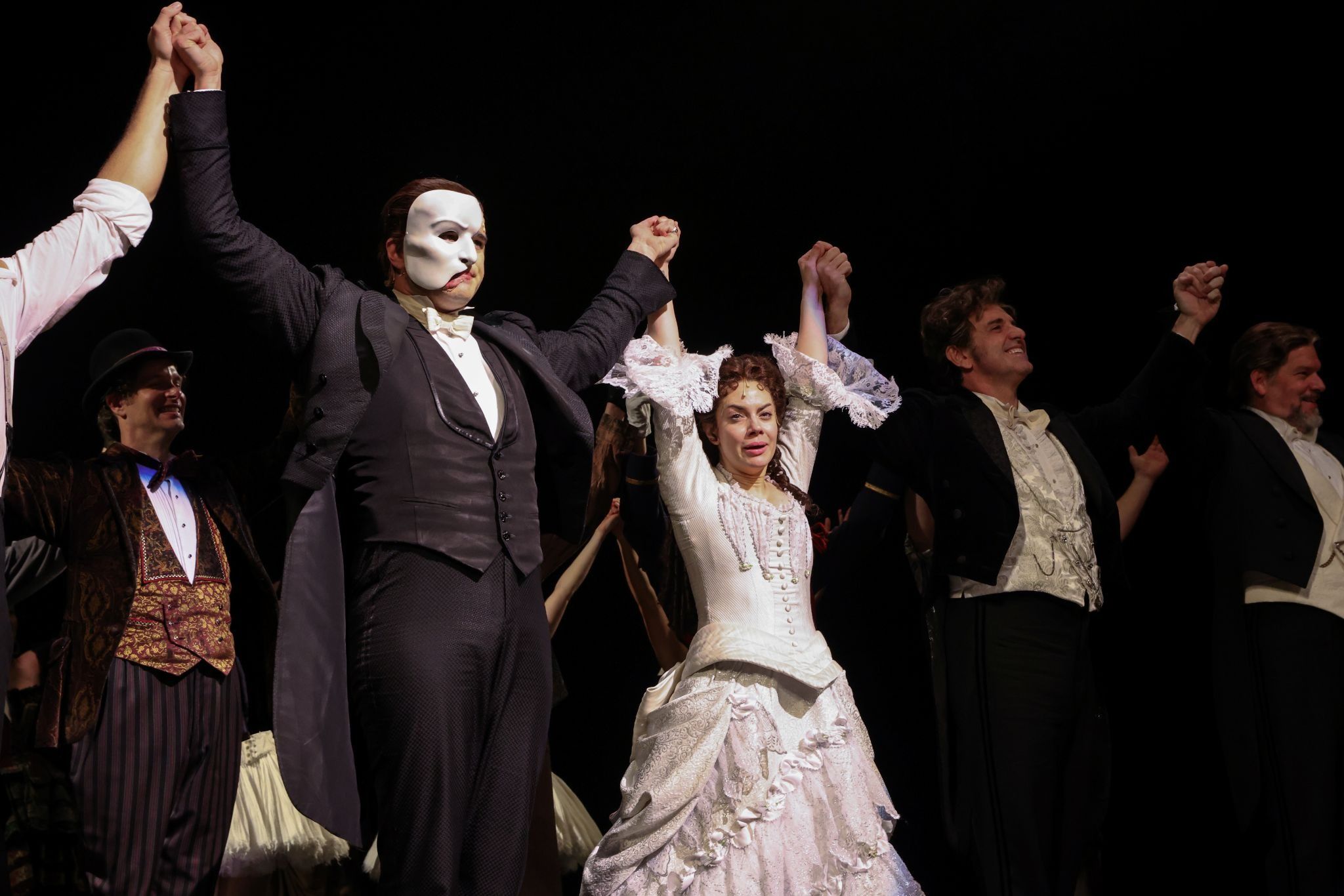 Actors Ben Crawford and Meghan Picerno stand on the stage with fellow cast members after performing on the re-opening night of “Phantom of the Opera” at the Majestic Theater in New York City, New York