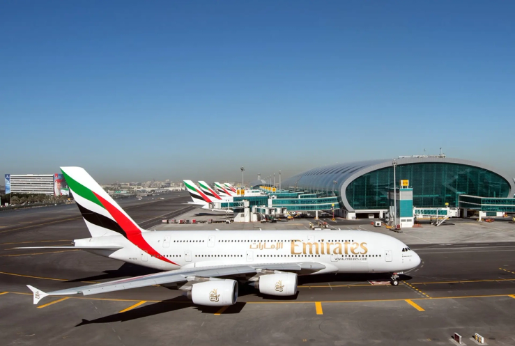 An Emirates plane is seen on the tarmac in an airport.