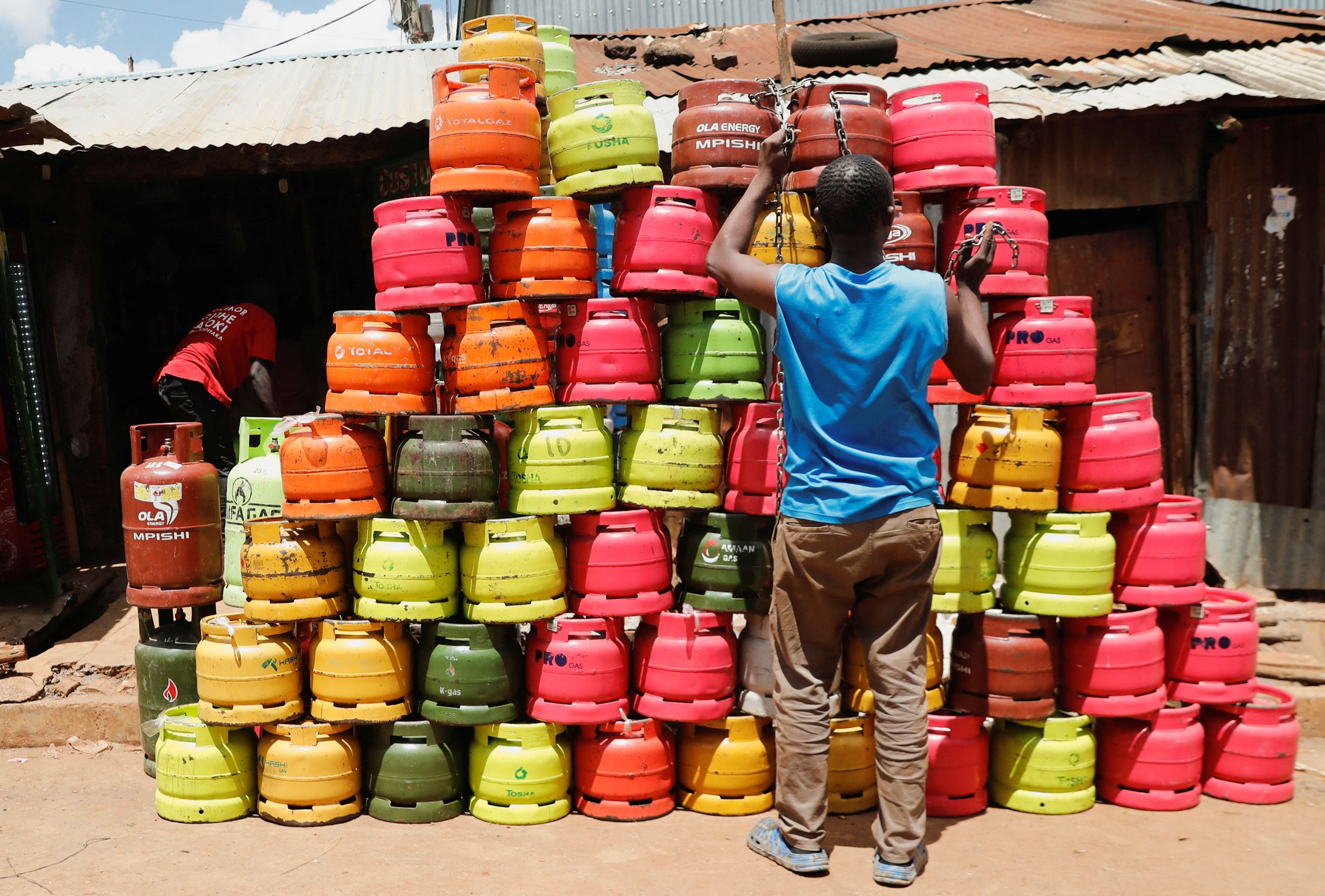 A man arranges cooking gas cylinders in Kibera settlement of Nairobi, Kenya.