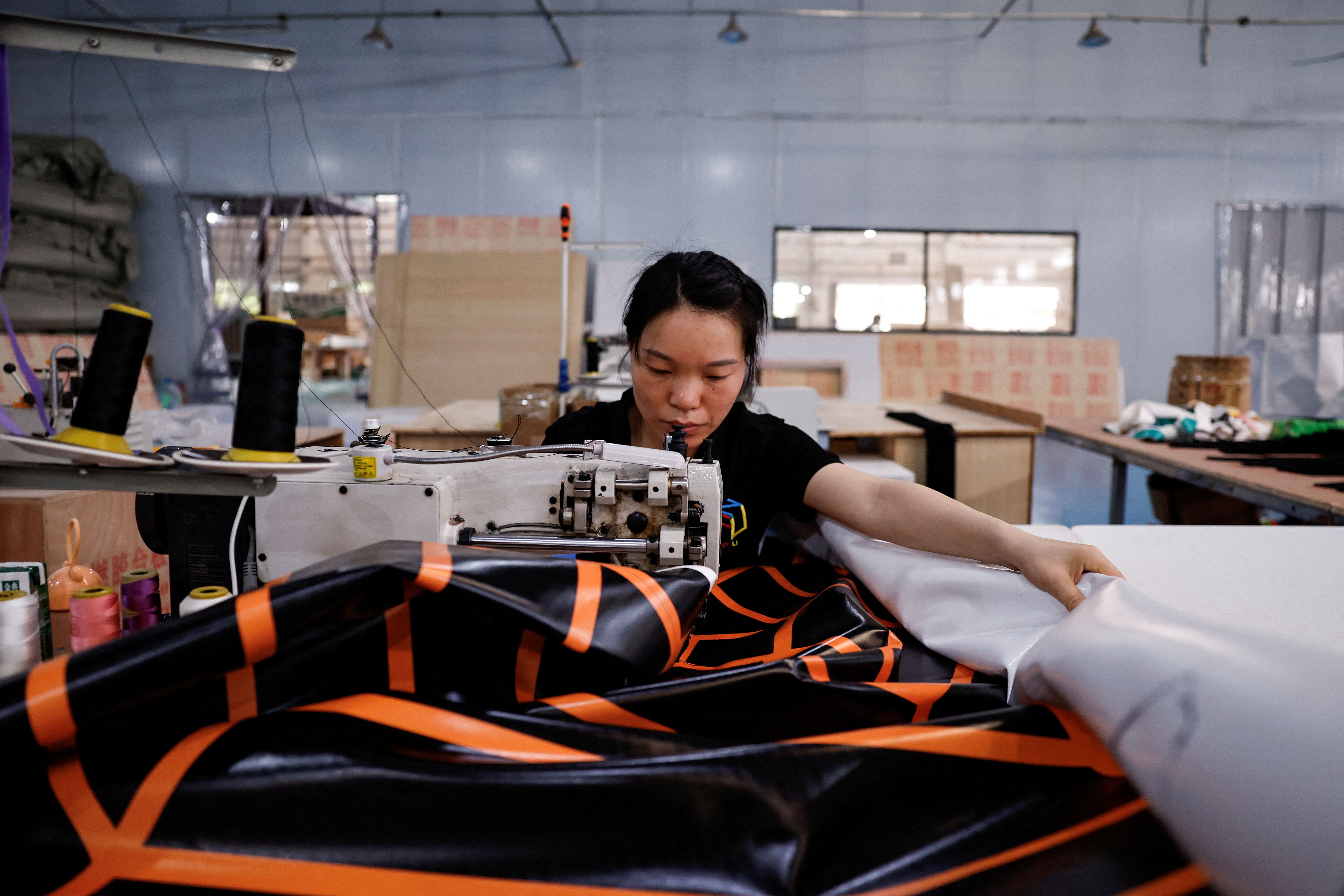 An employee works on a production line at the factory of Guangzhou Ifun Park Technology Co.