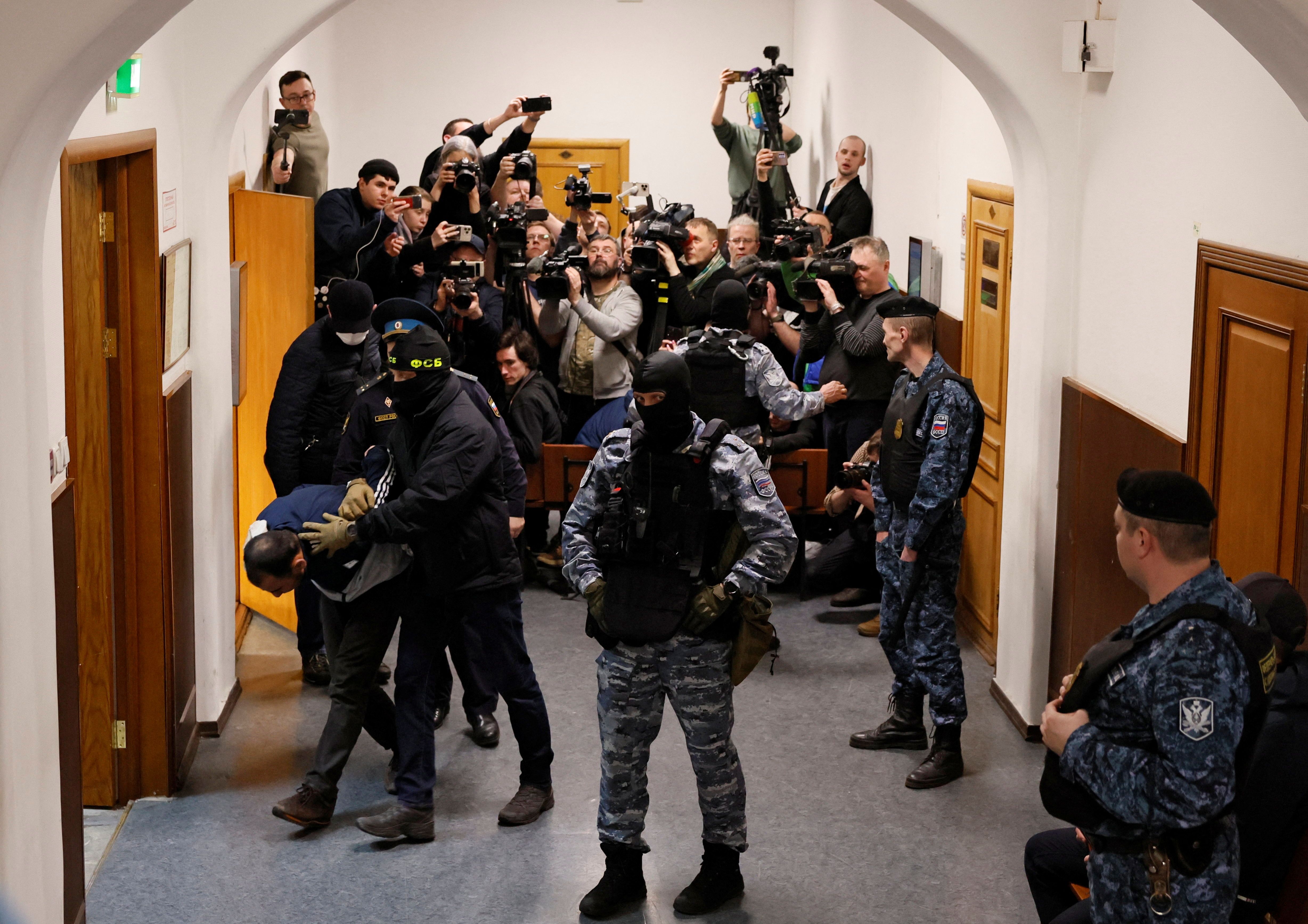 Saidakrami Murodali Rachabalizoda, a suspect in the shooting attack at the Crocus City Hall concert venue, is escorted after a court hearing at the Basmanny district court in Moscow, Russia March 24, 2024. REUTERS/Shamil Zhumatov