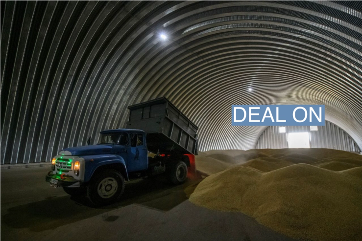 An employee unloads wheat grains inside a storage in the village of Zghurivka, amid Russia’s attack on Ukraine, in Kyiv region, Ukraine