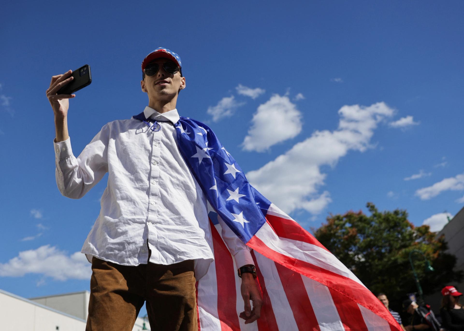 A man wearing an American flag at a Trump campaign event in Pennsylvania.