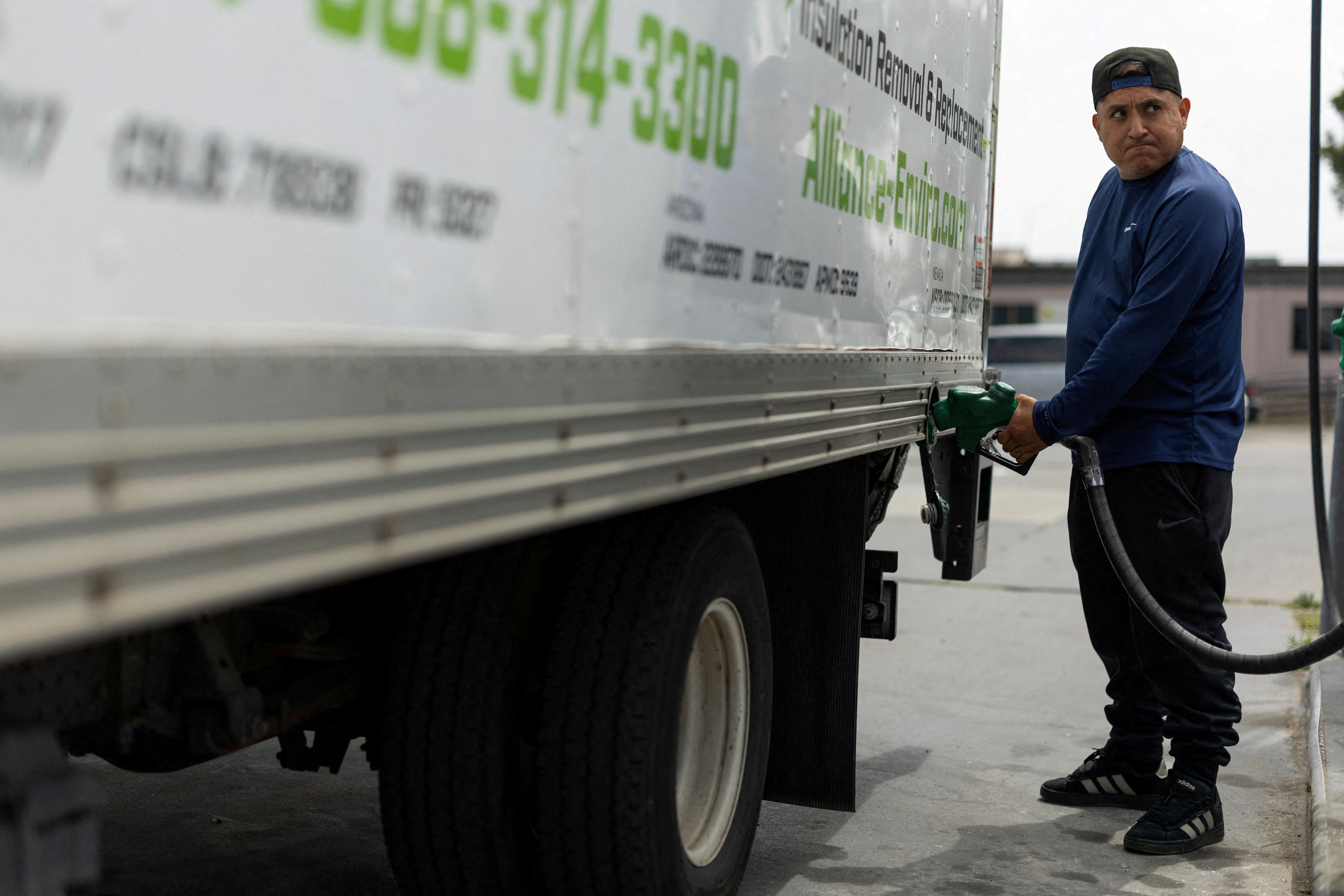 A man filling a truck with diesel fuel 