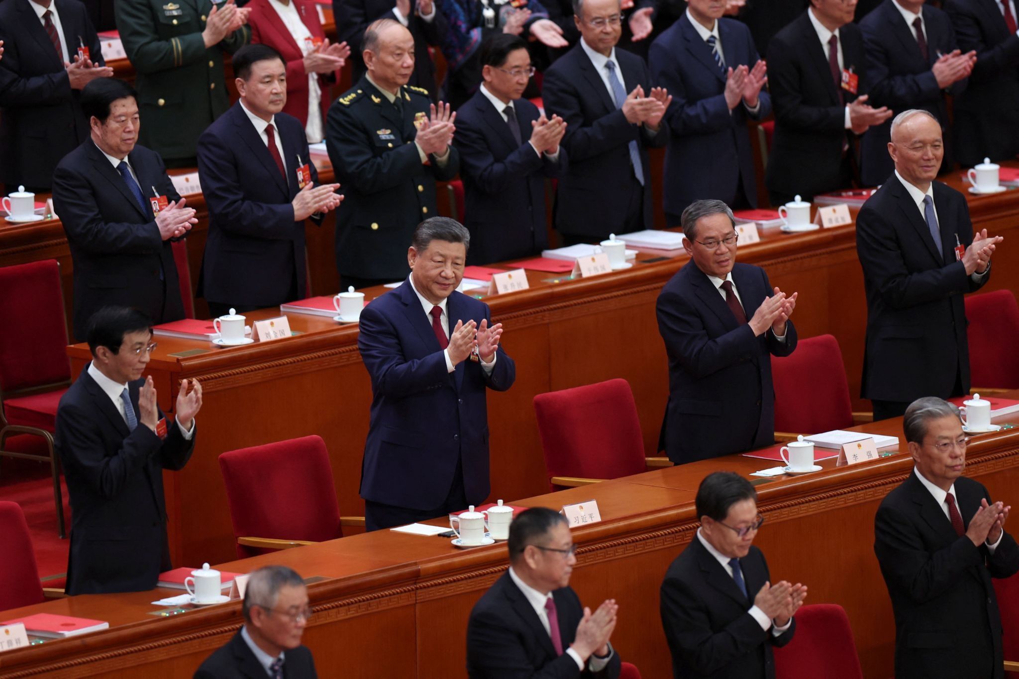 Chinese President Xi Jinping and other leaders applaud at the closing session of the National People’s Congress (NPC) at the Great Hall of the People in Beijing