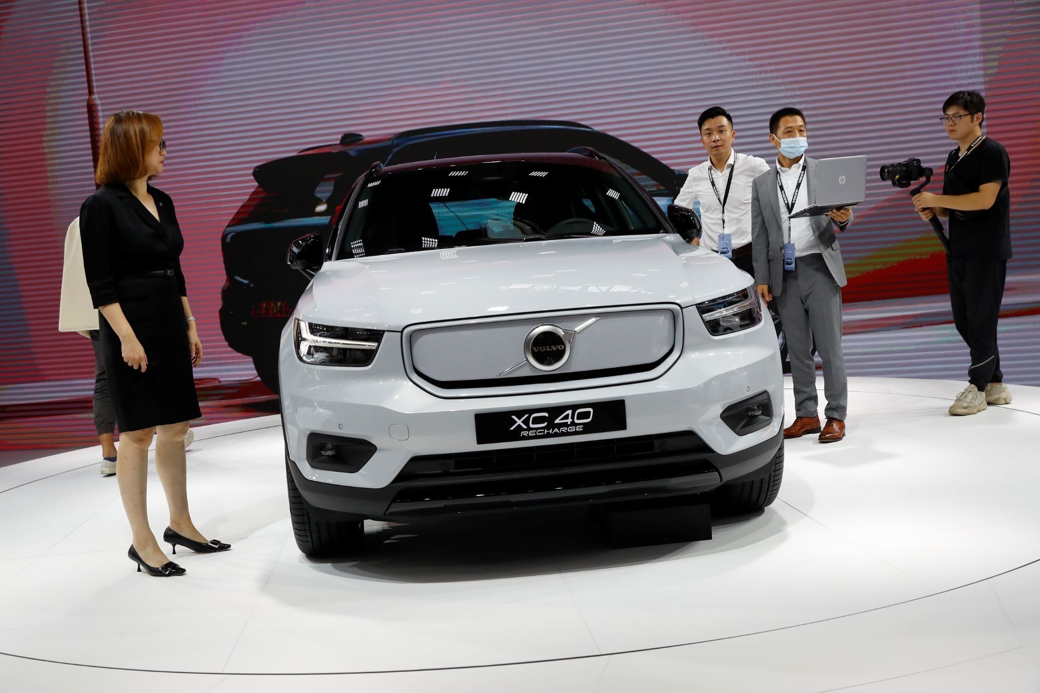 People look at a Volvo XC40 car during the Beijing International Automotive Exhibition, or Auto China show, in Beijing