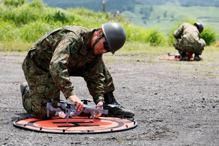 Members of the Japanese Self-Defense Force check drones in a live-fire drill.