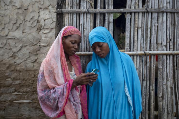 Women on their phones in Mozambique.
