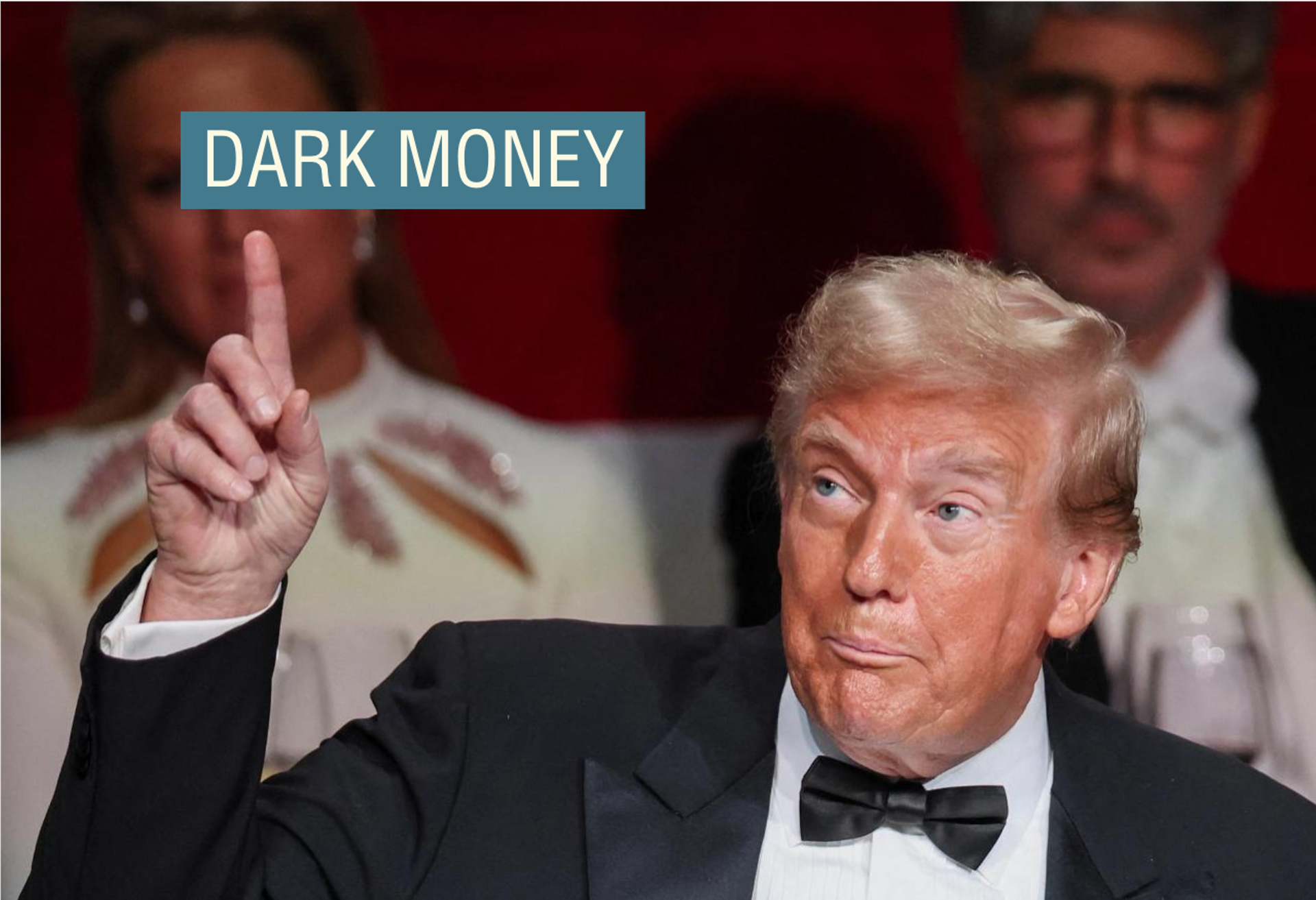 Donald Trump, wearing a black tuxedo, points to the ceiling at the 79th annual Alfred E. Smith Memorial Foundation Dinner in New York City