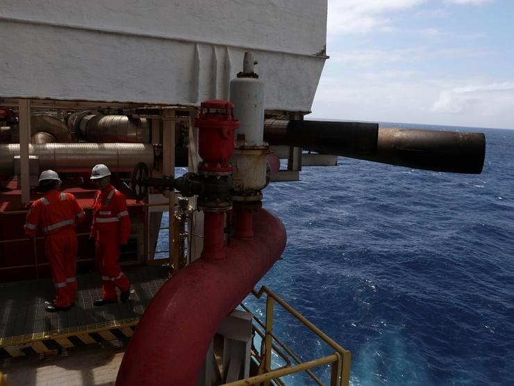 Workers inside an offshore oil rig.
