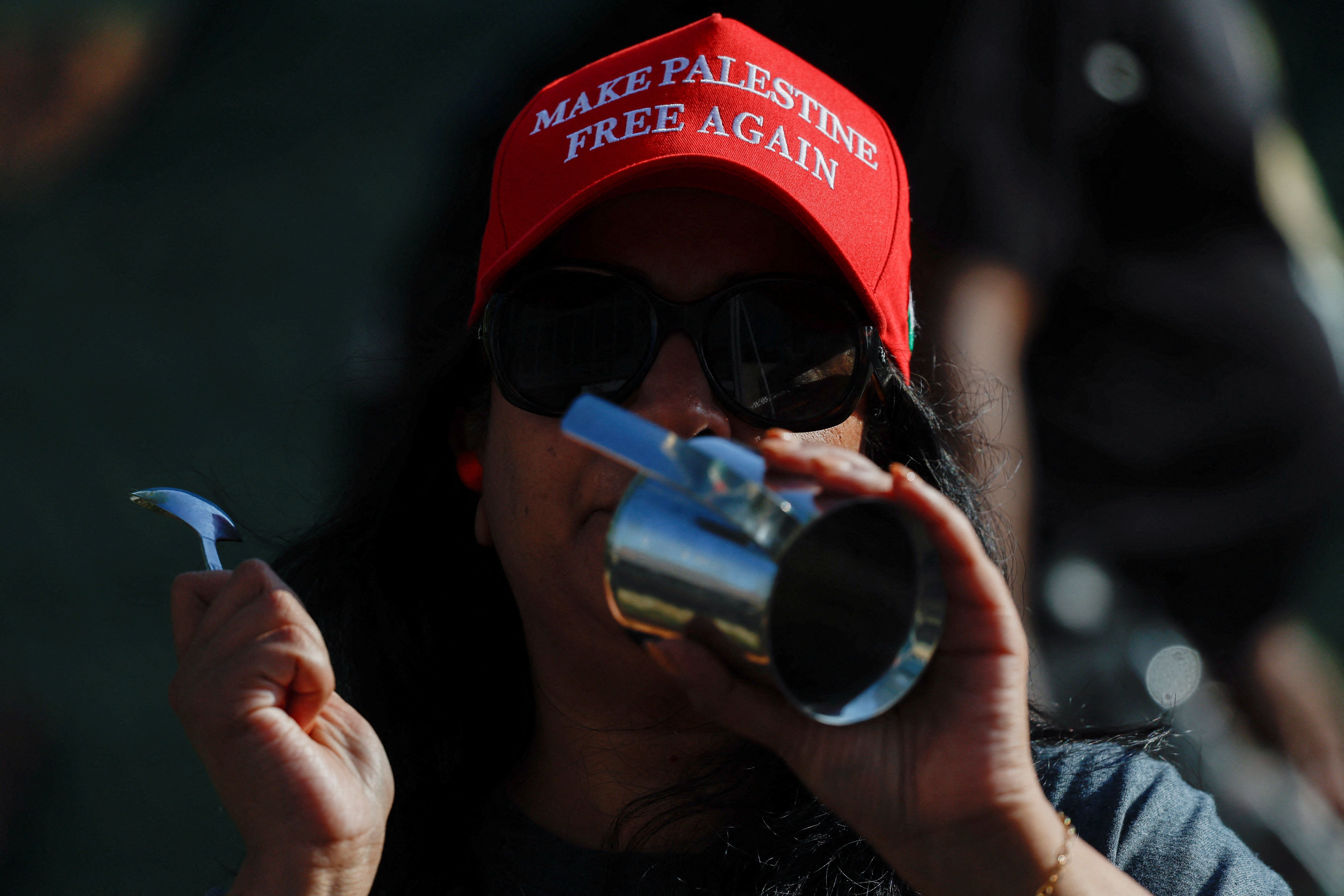 A demonstrator wears a red hat that reads “Make Palestine free again” during a protest against the U.S. backing of the Israeli military operation in Gaza, outside the Washington office of the American Israel Public Affairs Committee (AIPAC) in Washington, D.C.