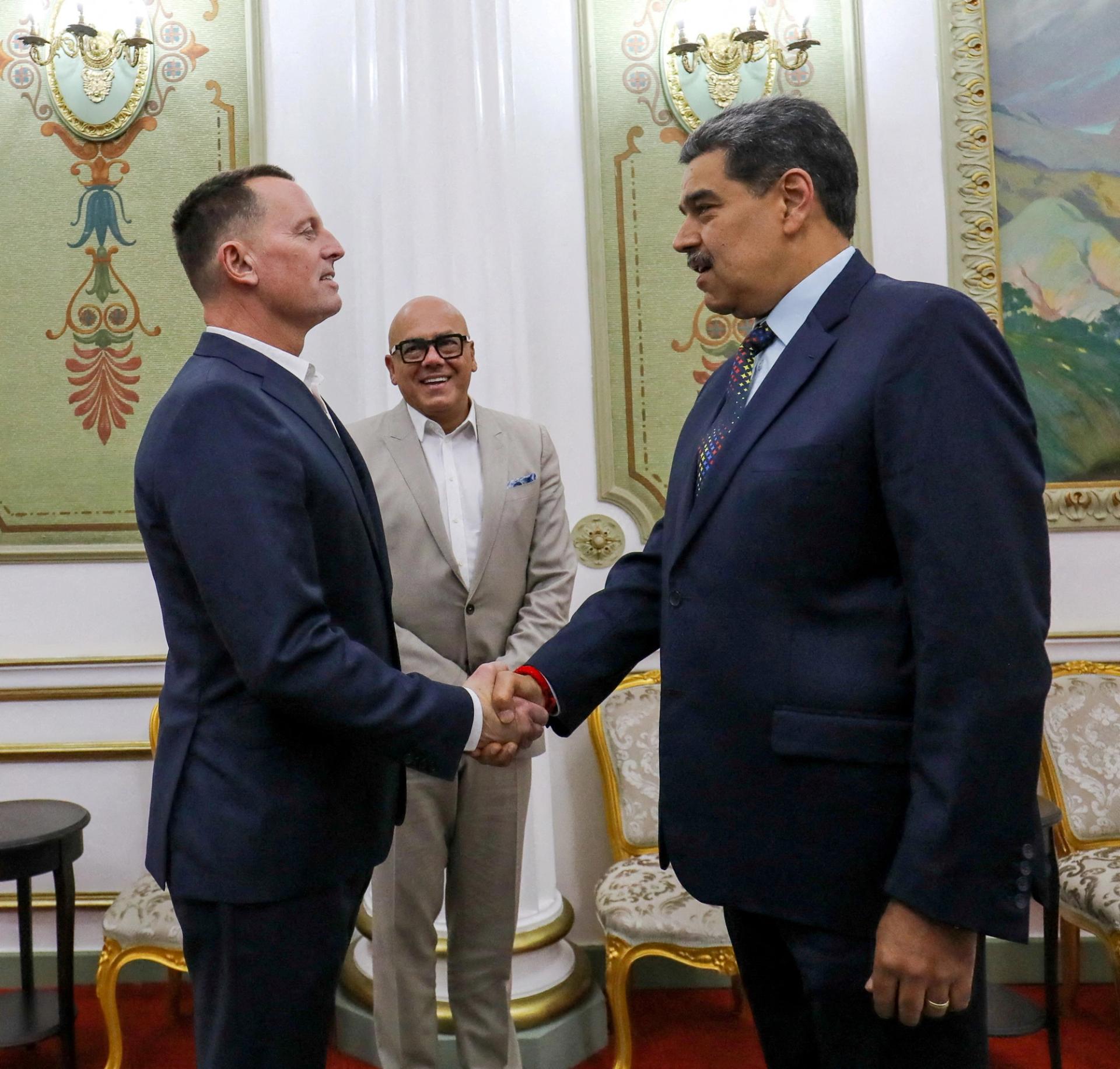 President Nicolas Maduro and US envoy Richard Grenell shake hands at the Miraflores Palace, in Caracas.