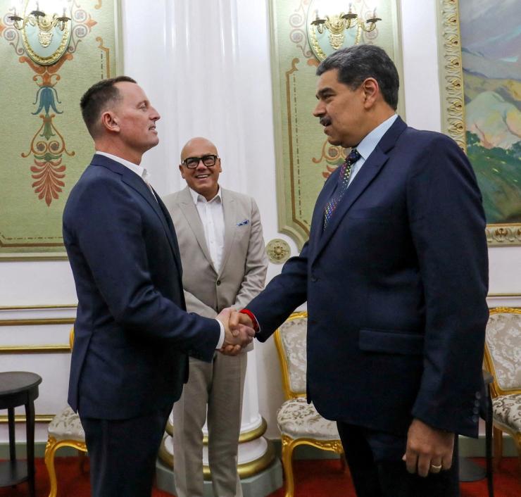 President Nicolas Maduro and US envoy Richard Grenell shake hands at the Miraflores Palace, in Caracas.