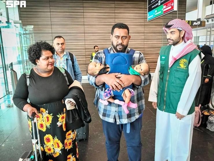 Fijian twins Jesibel and Desisia arrive in Riyadh, Saudi Arabia with their parents, on July 31
