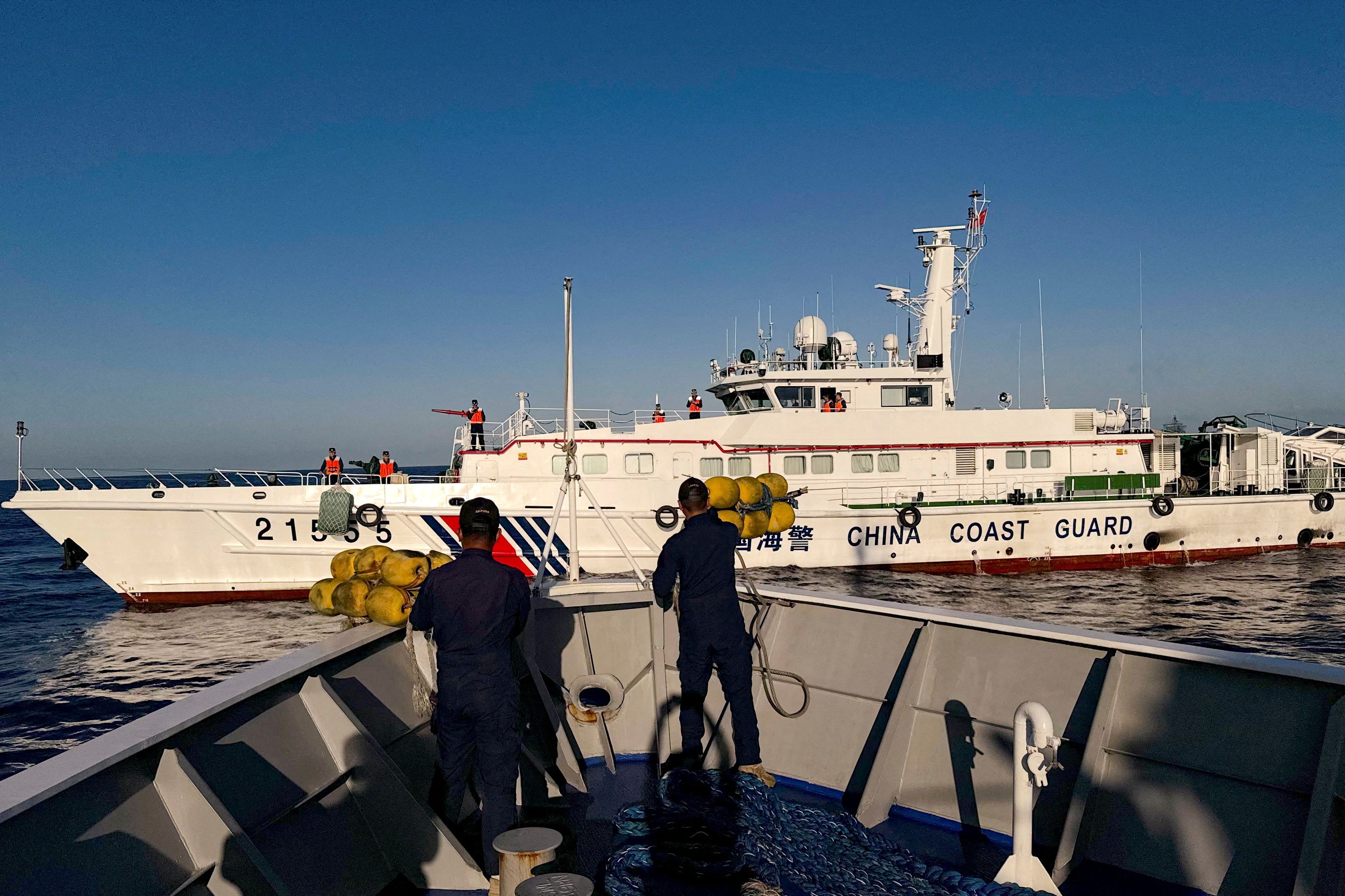 Philippine Coast Guard personnel prepare rubber fenders after Chinese Coast Guard vessels blocked their way to a resupply mission at the Second Thomas Shoal in the South China Sea, March 5, 2024.