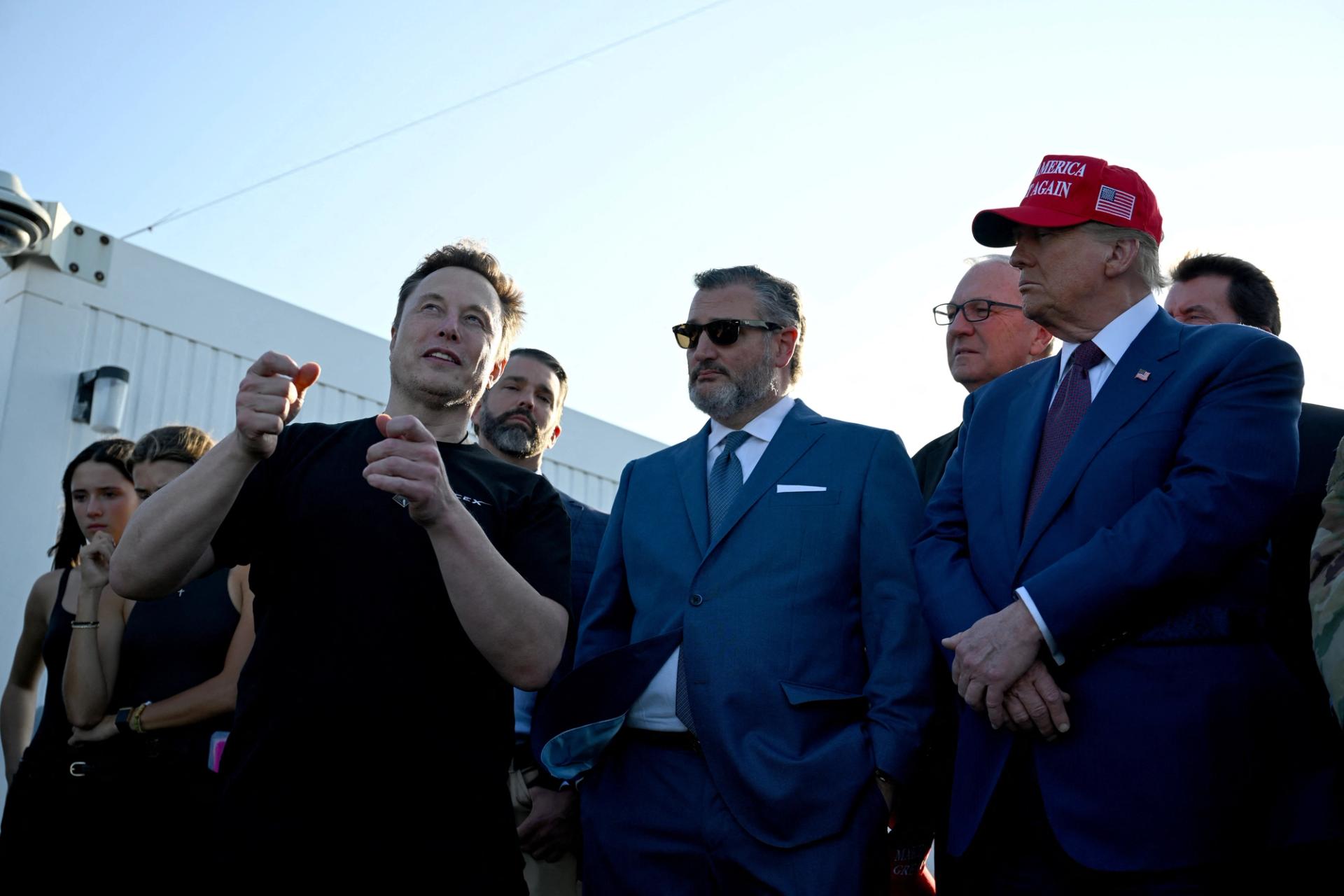 Elon Musk speaks with US President-elect Donald Trump and guests including Donald Trump Jr., Sen. Ted Cruz (R-TX) and Kevin Cramer (R-ND) at a viewing of the launch of the sixth test flight of the SpaceX Starship, in Brownsville, Texas