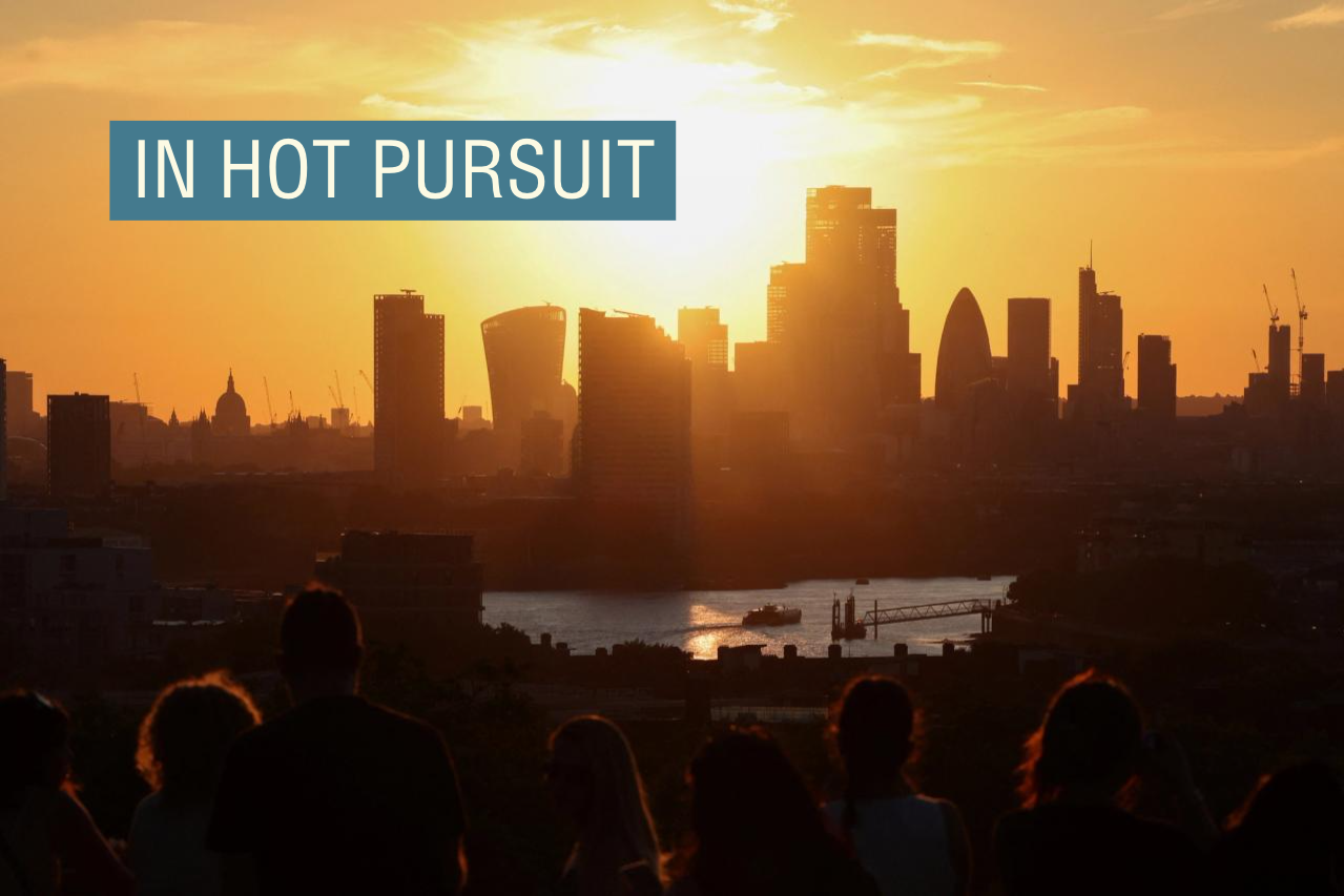 People watch the sunset over the city from Greenwich Park in London.