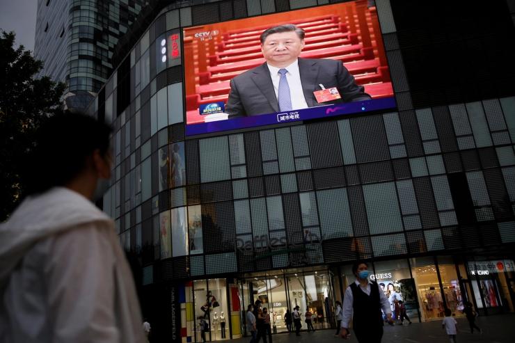 A giant screen on the facade of a shopping mall shows news footage of Chinese President Xi Jinping at the closing session of the National People’s Congress (NPC), in Beijing