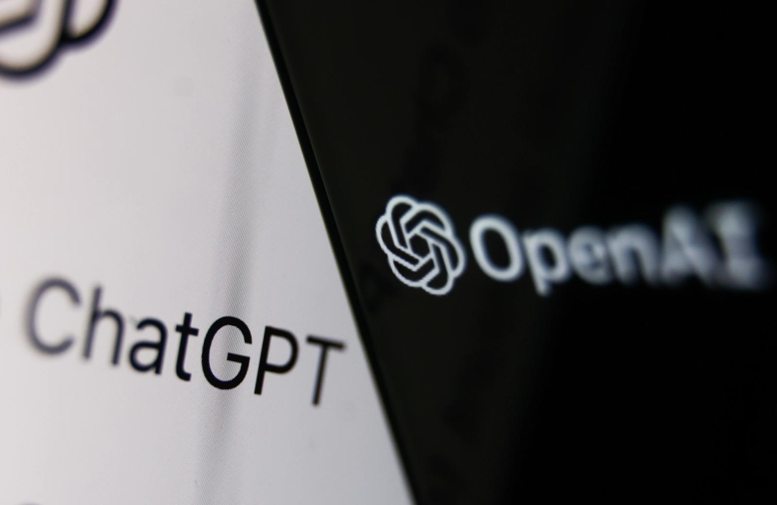 OpenAI logo displayed on a phone screen and ChatGPT website displayed.