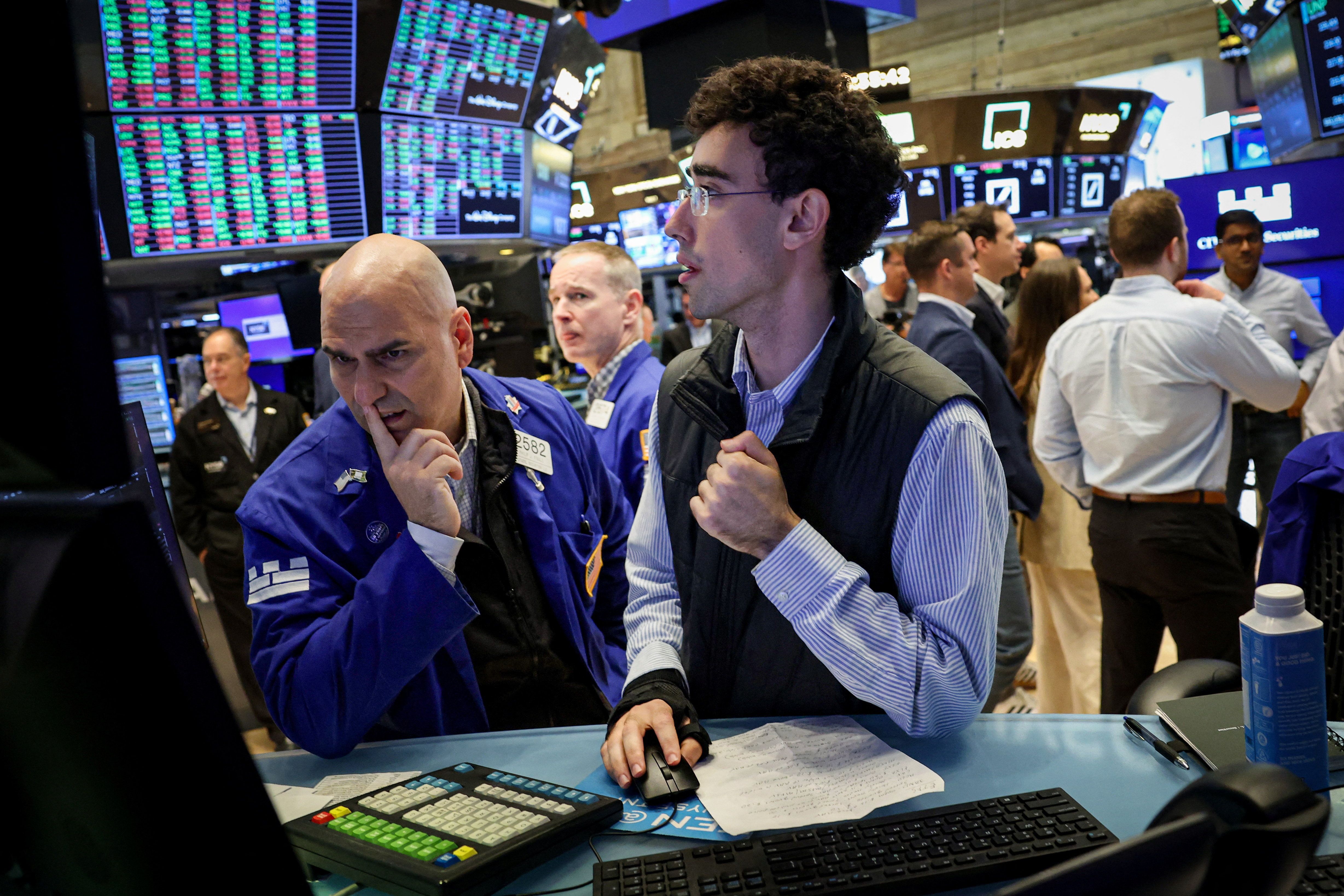 Specialist traders work on the floor at the New York Stock Exchange.