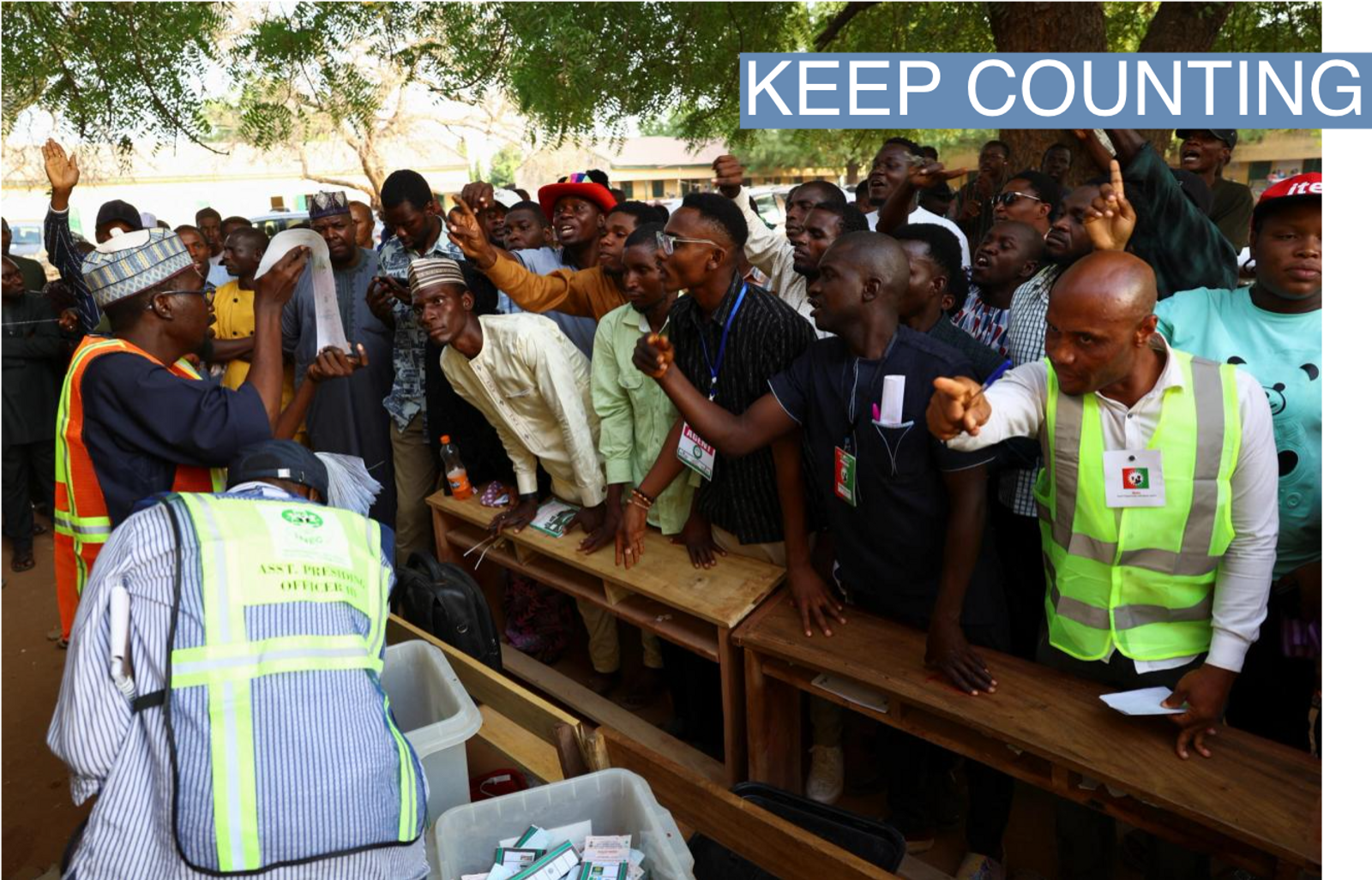 Party agents react during the counting of ballots, after voting ended, at a polling station, in Nigeria's presidential election, in Yola, Nigeria, February 25, 2023. 