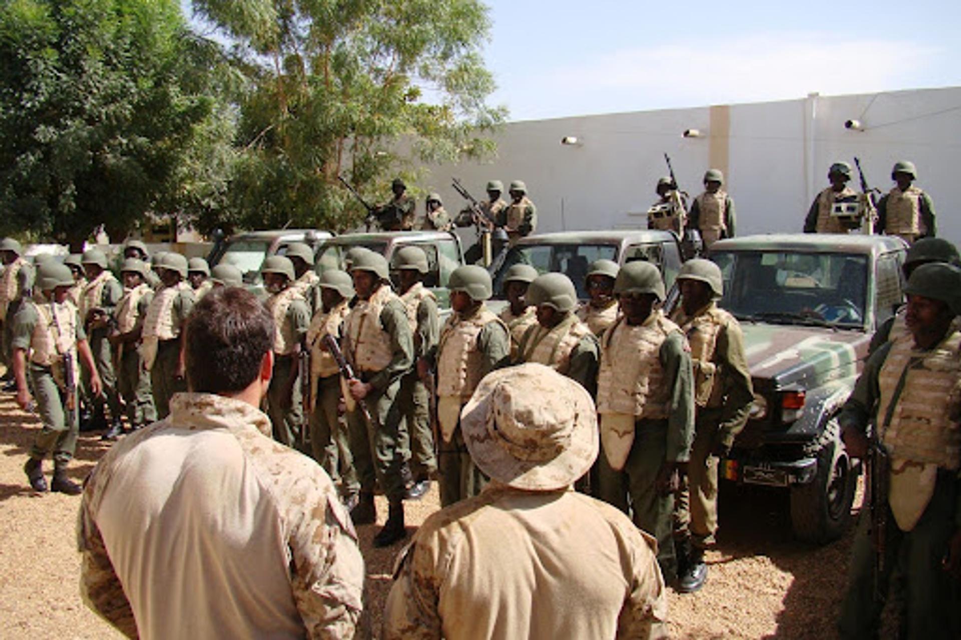 Members of a Malian special operations unit conduct an equipment inspection as two US Navy SEALs look on, on Feb. 26, 2010, near Gao, Mali. 