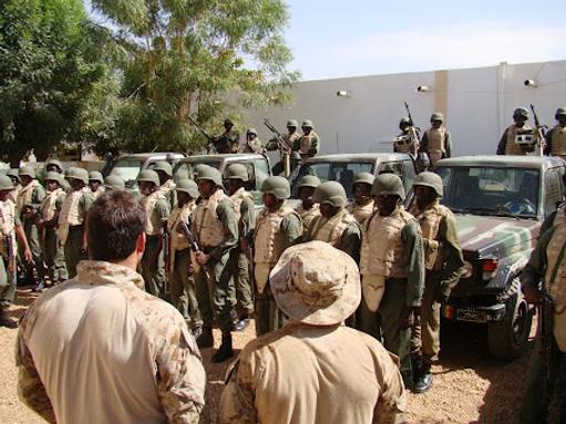 Members of a Malian special operations unit conduct an equipment inspection as two US Navy SEALs look on, on Feb. 26, 2010, near Gao, Mali.