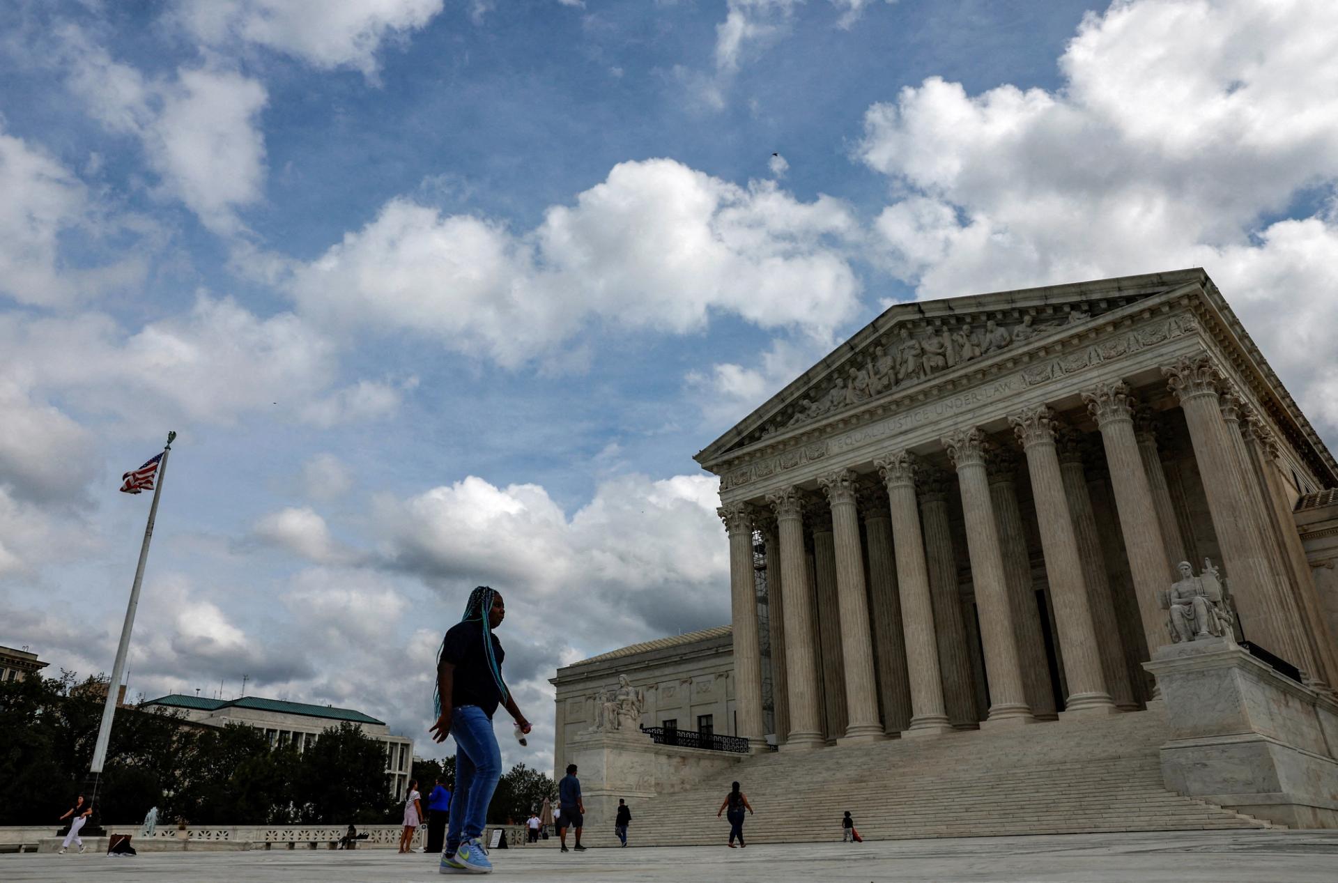 Visitors walk in front of the United States Supreme Court building in Washington, U.S., September 22, 2023. 
