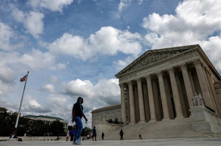 Visitors walk in front of the United States Supreme Court building in Washington, U.S., September 22, 2023.