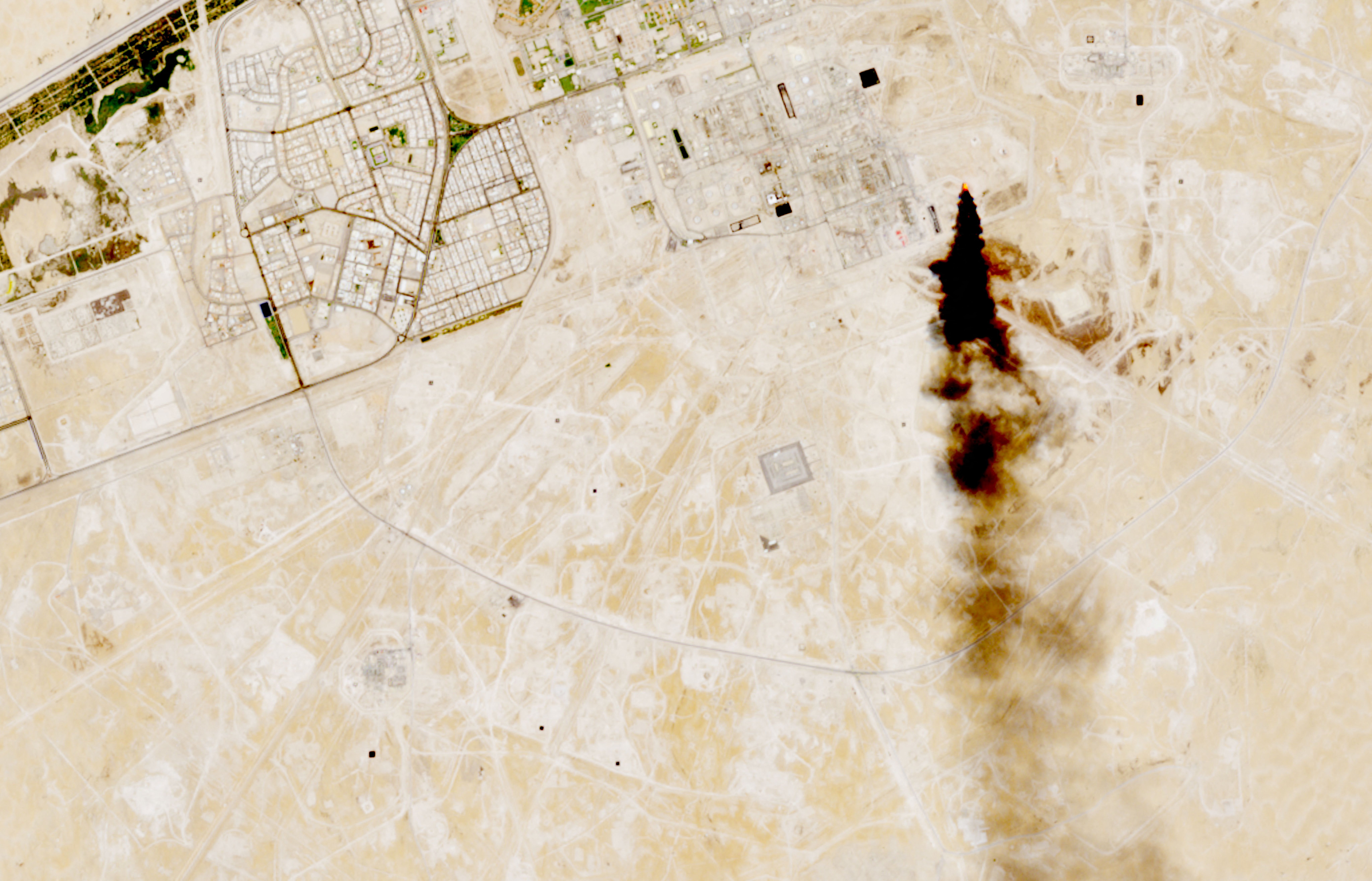 A satellite image shows smoke coming out of an oil facility in Saudi Arabia