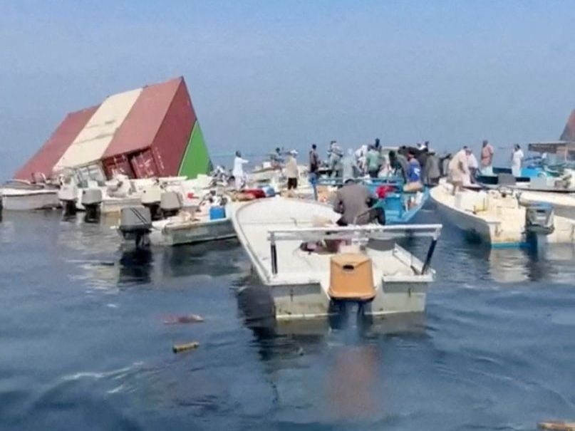 Containers float in the water after a vessel sank near the Strait of Hormuz off the coast of Oman, in this still image obtained from a social media video, released Oct. 14, 2026. 