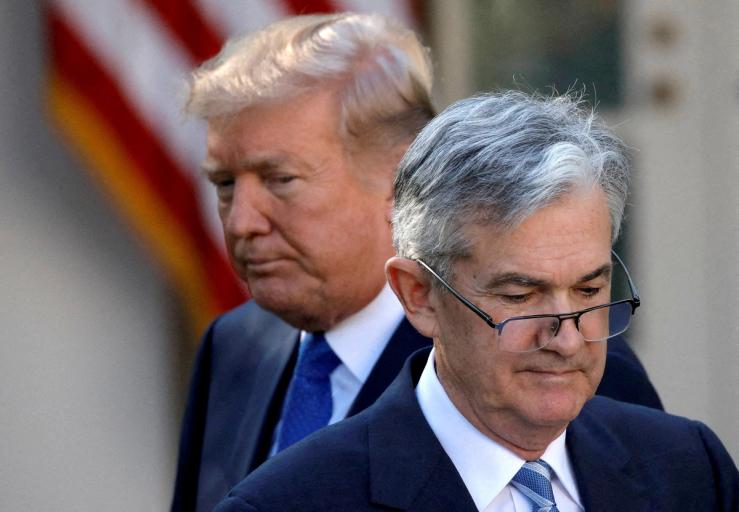 U.S. President Donald Trump looks on as Jerome Powell.