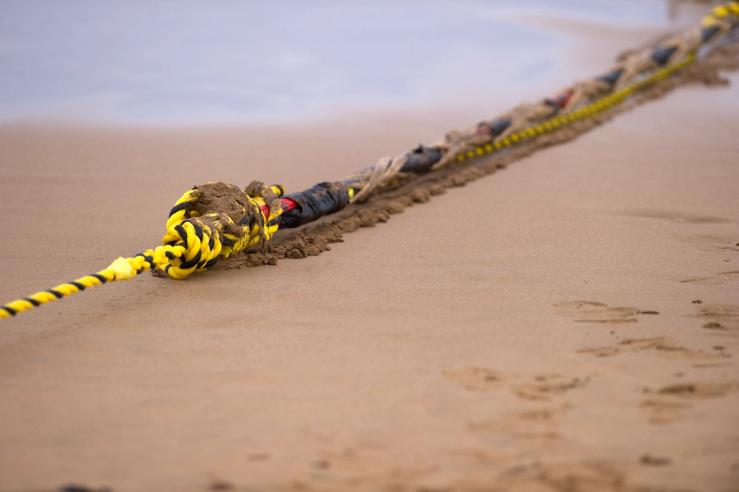 An undersea fiber optic cable is attached to a rope at Arrietara beach near the Spanish Basque village of Sopelana on June 13, 2017.