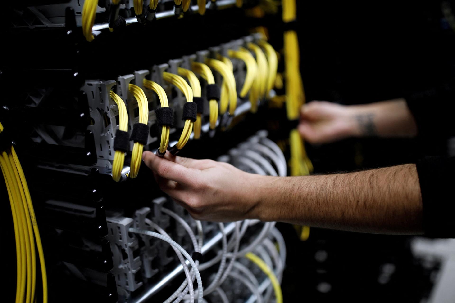 Cables run into the back of a server unit inside the data center of Equinix in Pantin, near Paris, in 2016.