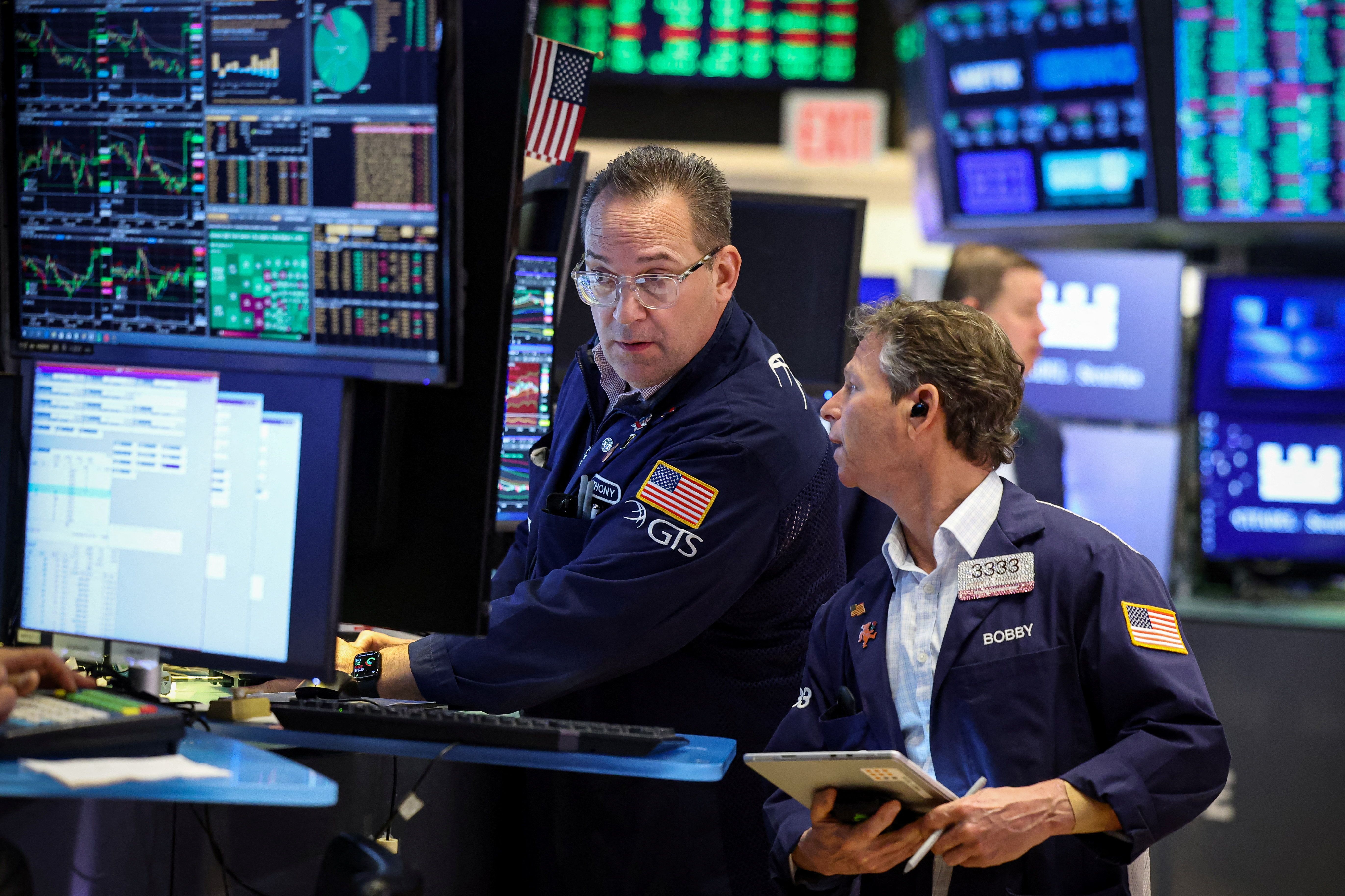 Traders work on the floor of the NYSE in New York