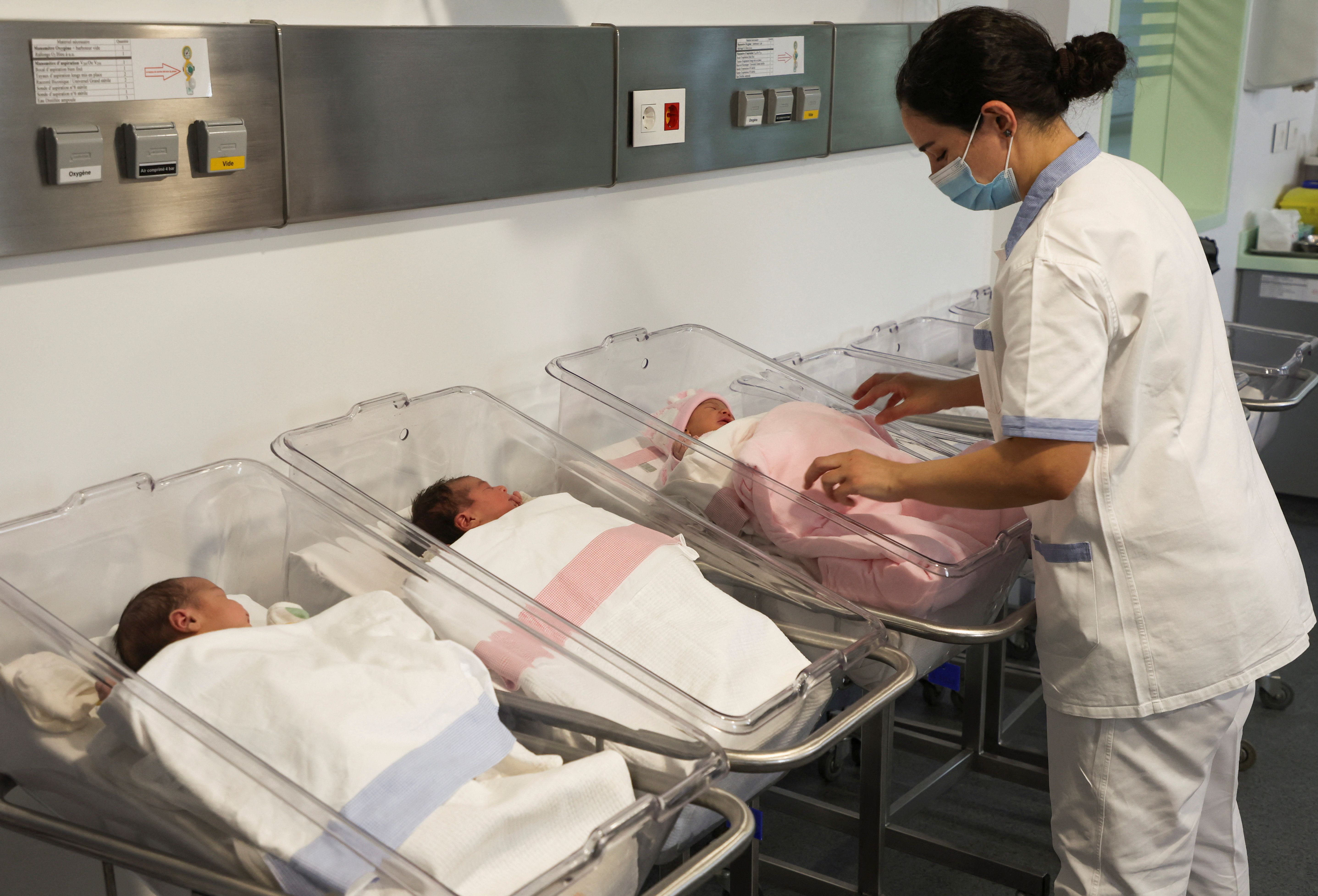 A medical worker stands near newborn babies at Hotel Dieu hospital in Beirut