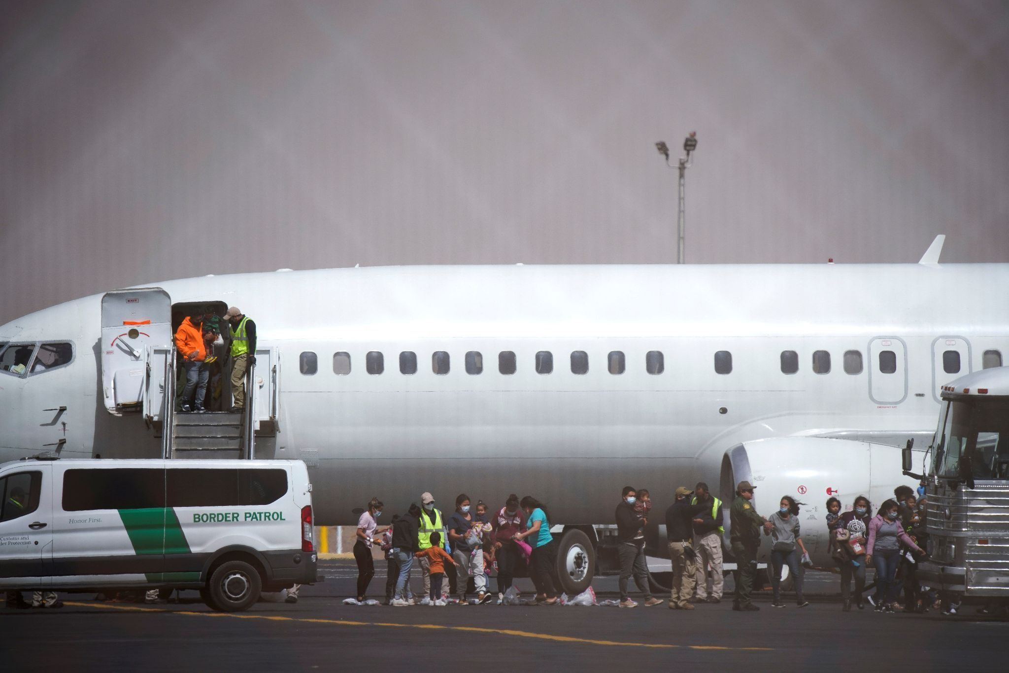 Migrants leave a chartered flight from Brownsville, Texas.