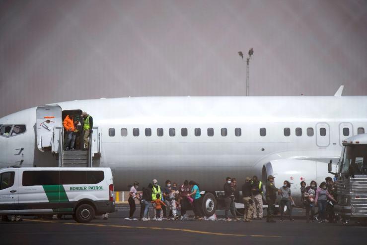 Migrants leave a chartered flight from Brownsville, Texas.