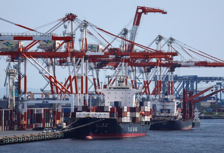 A cargo ship carrying containers is seen at an industrial port within Tokyo Port, Japan