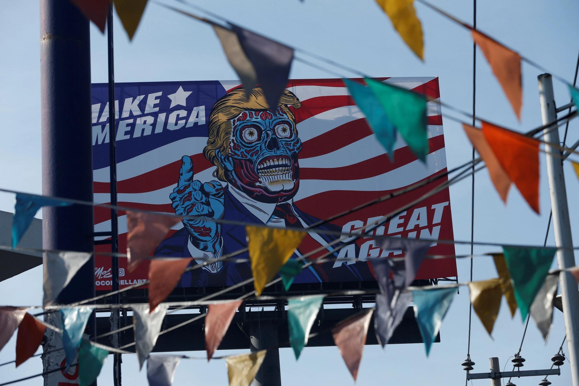 A giant billboard shows a drawing depicting U.S. President Donald Trump.