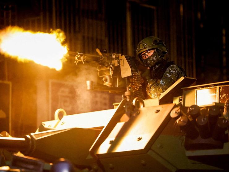 A Taiwanese military member fires ammunition during military exercises
