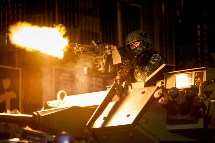 A Taiwanese military member fires ammunition during military exercises