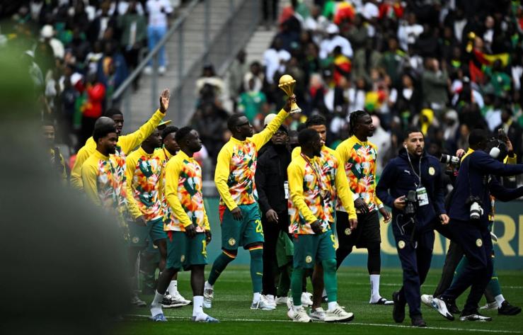 Senegal parades its AFCON trophy before a friendly game with Peru in France.
