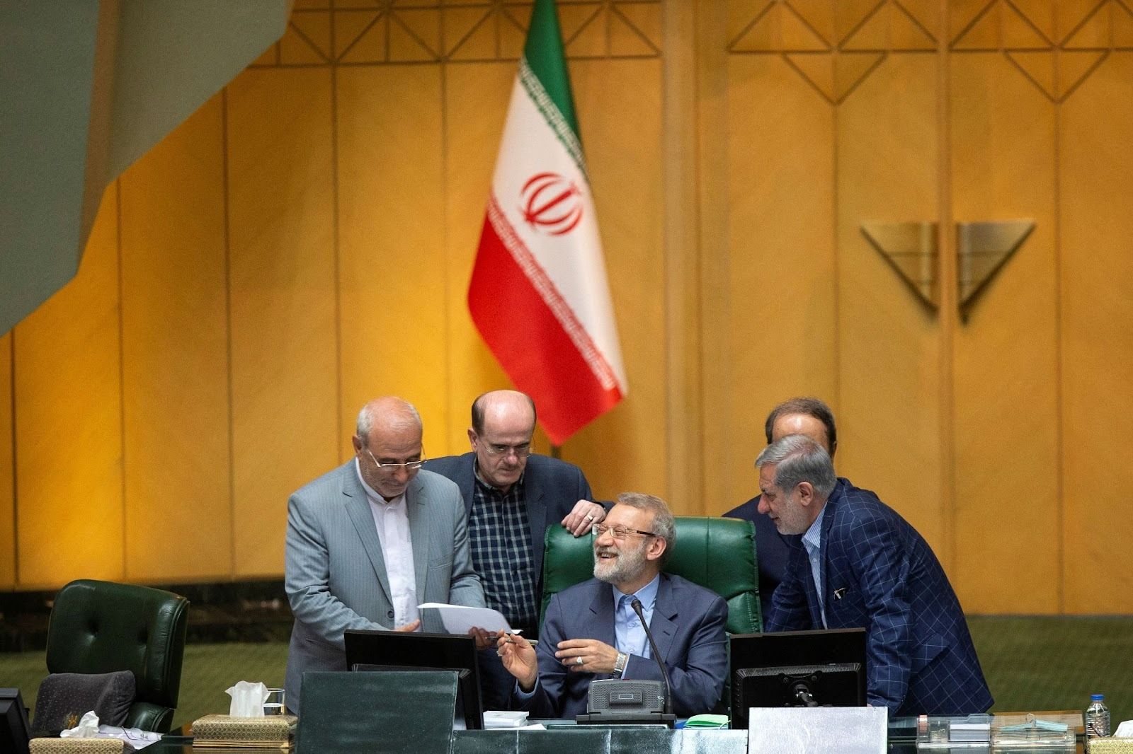 Ali Larijani, seated, during a parliamentary session. 