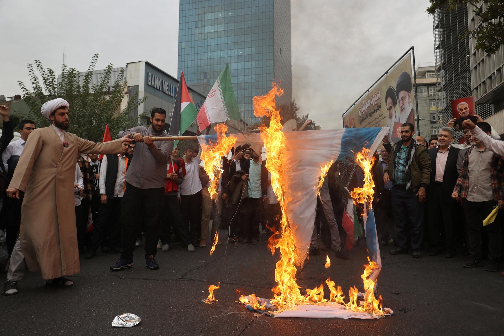 Iranians in Tehran burn an Israeli flag during the 45th anniversary of the U.S. expulsion from Iran, on November 3, 2024.