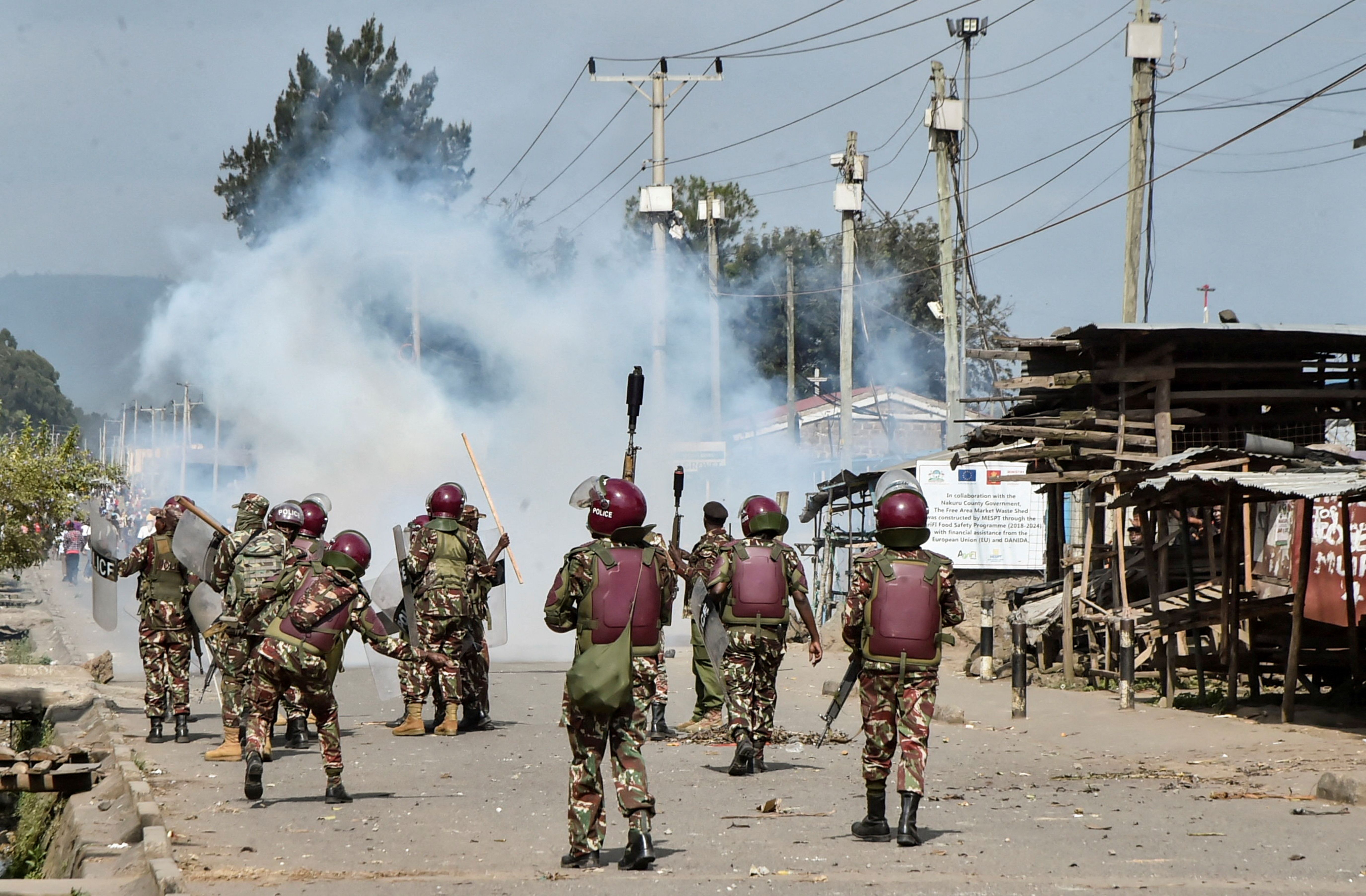 Riot police officers fire tear gas canisters to disperse demonstrators during anti-government protests dubbed “Saba Saba People’s March.”