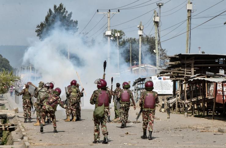 Riot police officers fire tear gas canisters to disperse demonstrators during anti-government protests dubbed “Saba Saba People’s March.”