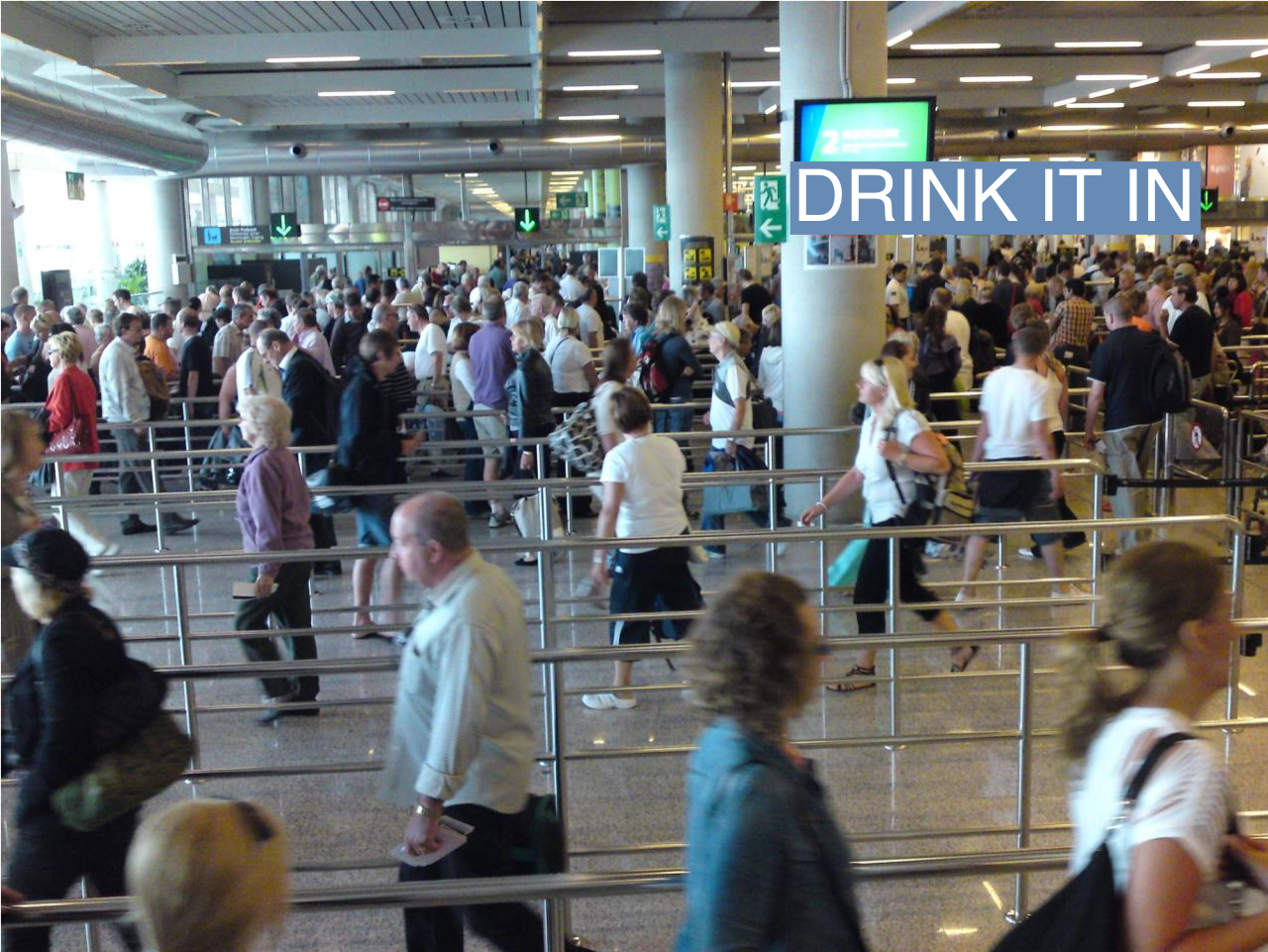 People queue for security at London City Airport.