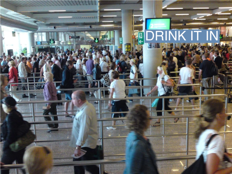People queue for security at London City Airport.