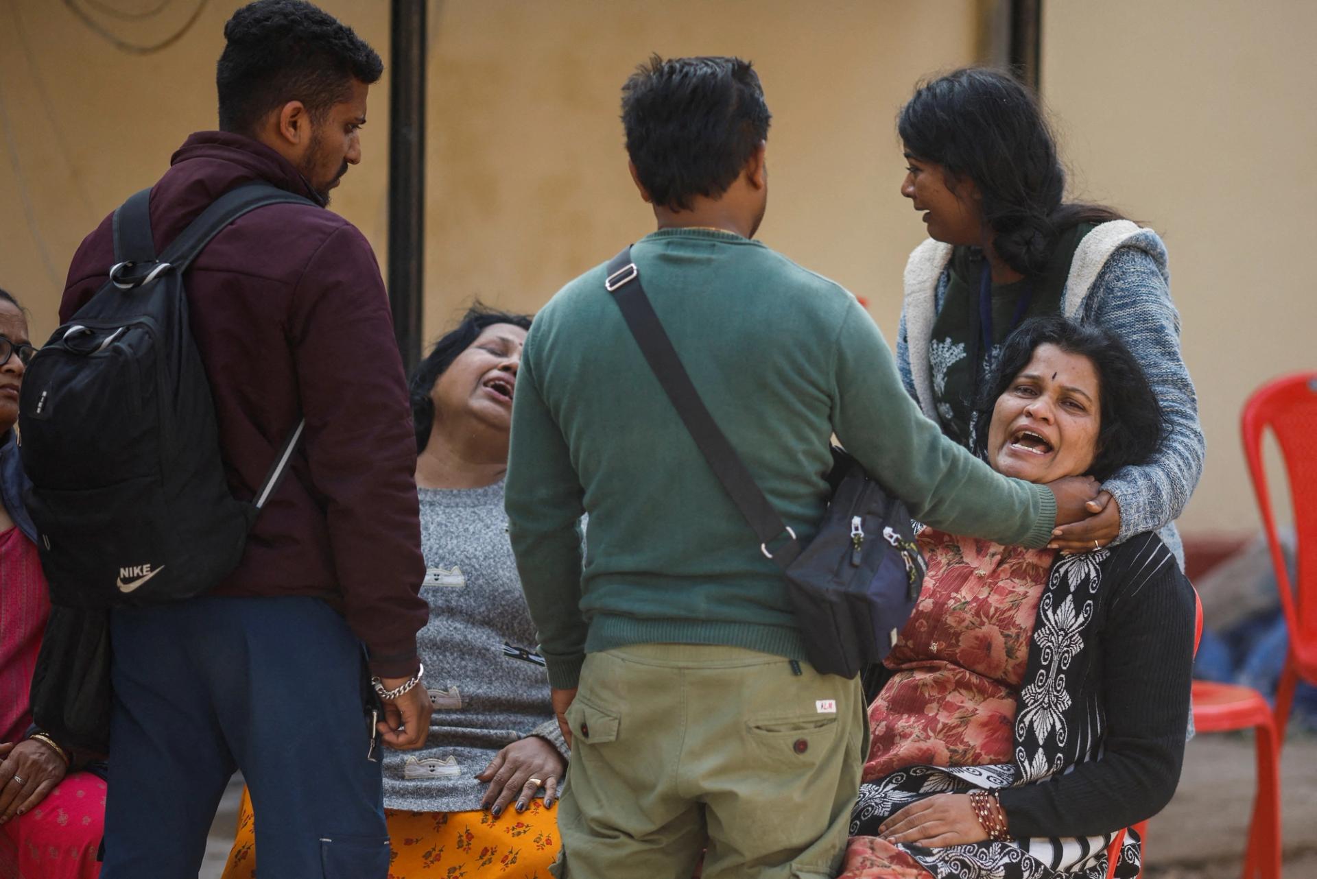 People gather at a hospital mortuary after the stampede